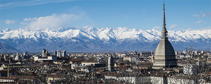 Turin rooftops with mountains in background